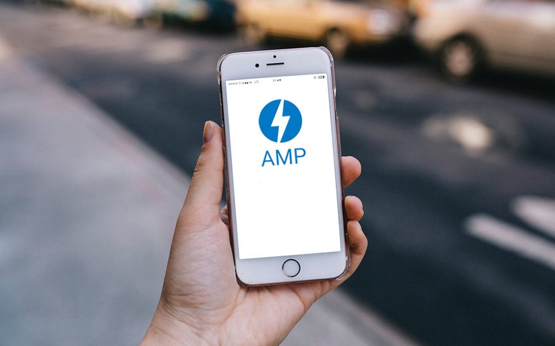 Hand holding an iPhone with the AMP icon showing on the screen.